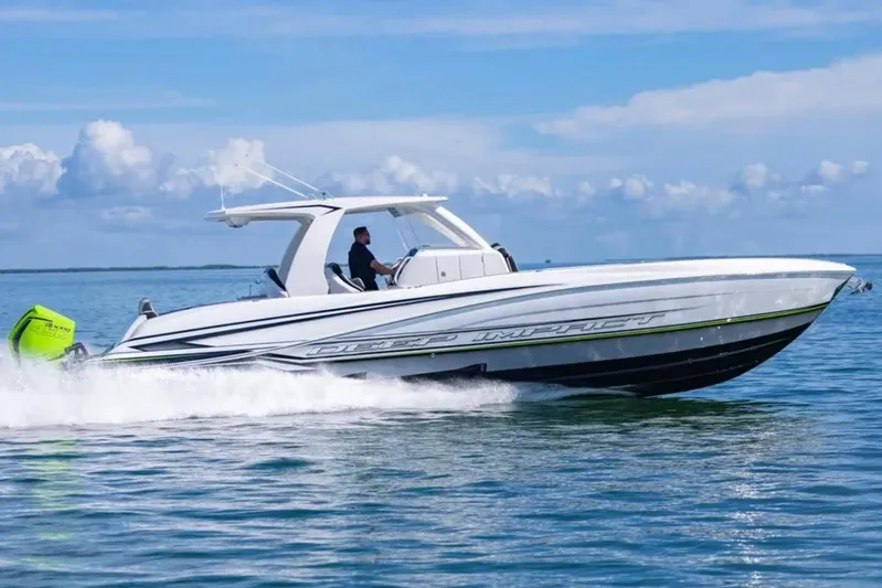  Yacht Photos Pics 2026 Deep Impact 399 Sport boat cruising on open water under a clear sky.