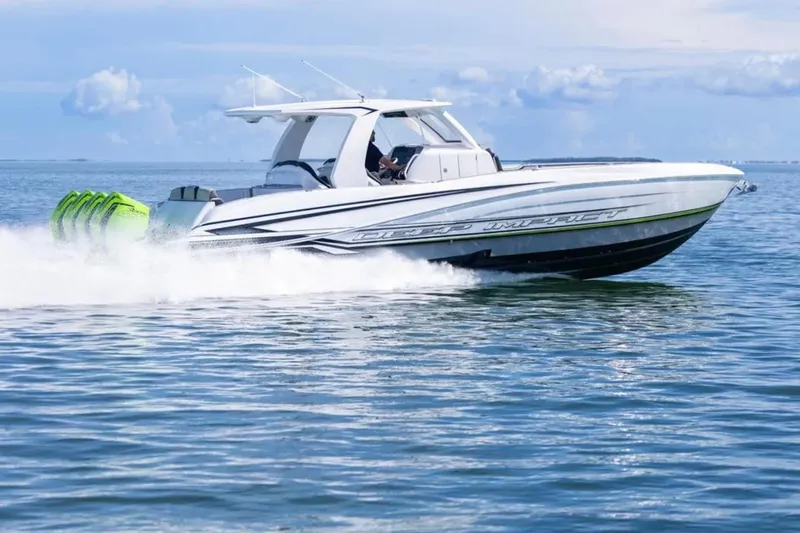  Yacht Photos Pics 2026 Deep Impact 399 Sport boat speeding on open water under a clear sky.