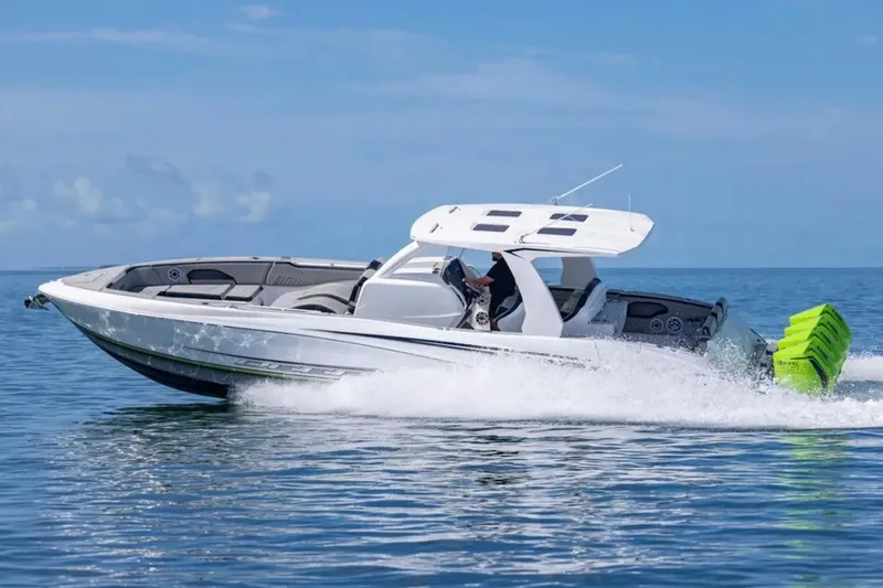  Yacht Photos Pics 2026 Deep Impact 399 Sport boat cruising on open water, showcasing sleek design and powerful engines.