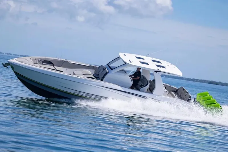  Yacht Photos Pics 2026 Deep Impact 399 Sport boat cruising on open water, showcasing sleek design and performance.