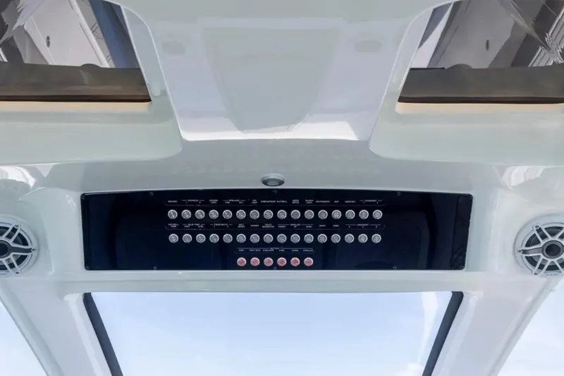  Yacht Photos Pics Control panel of 2026 Deep Impact 399 Sport boat, featuring multiple buttons and speakers.