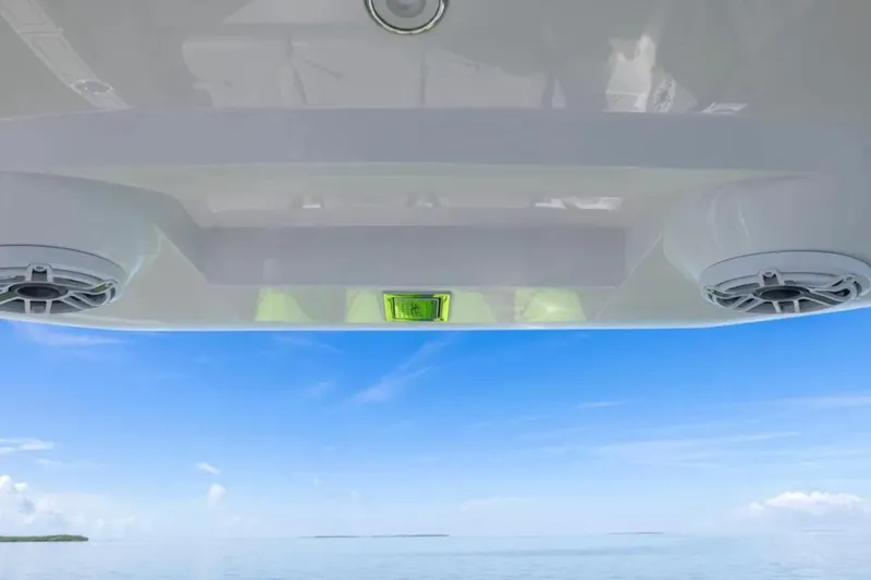  Yacht Photos Pics 2026 Deep Impact 399 Sport boat speakers with ocean view under clear blue sky.