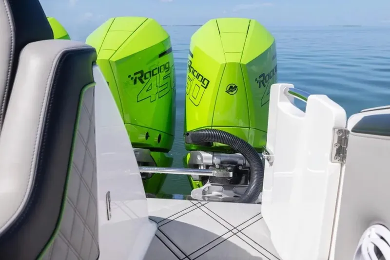  Yacht Photos Pics 2026 Deep Impact 399 Sport boat with vibrant green racing engines on calm water.