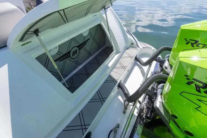  Yacht Photos Pics 2026 Deep Impact 399 Sport boat with open storage and vibrant green engines.