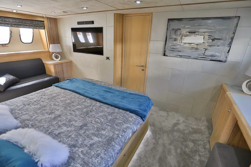 Black Zen Yacht Photos Pics Luxurious bedroom interior of 2006 Sunseeker Predator 82 yacht with modern decor and cozy furnishings.