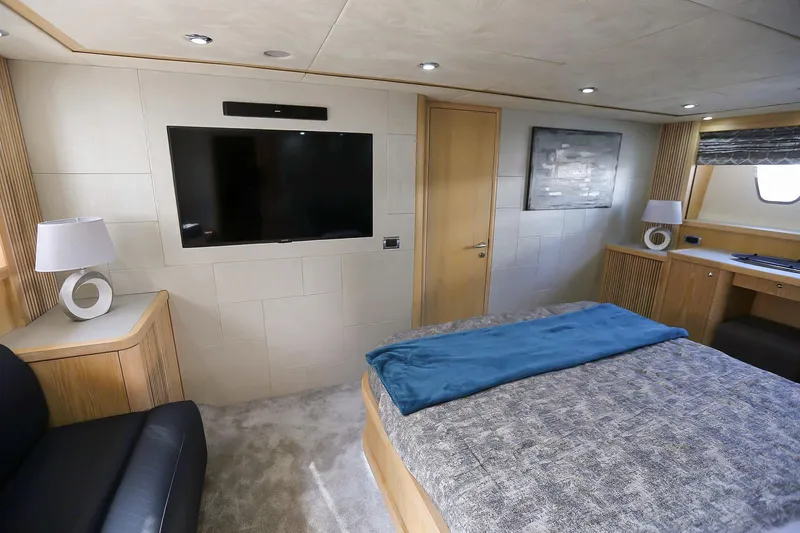 Black Zen Yacht Photos Pics Luxurious bedroom interior of 2006 Sunseeker Predator 82 yacht with modern decor and large TV.