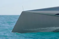 Sleek Custom VSV boat cutting through ocean waves, 2007 model.