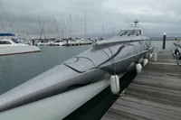 Custom 2007 VSV yacht docked at marina, sleek design, surrounded by sailboats under cloudy sky.