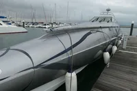 Custom 2007 VSV boat docked at marina with sleek design and fenders.