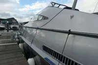 Custom VSV 2007 yacht docked at marina, sleek design, cloudy sky background.
