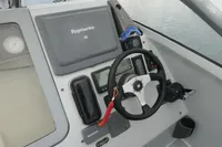 Boat cockpit with Raymarine navigation system, steering wheel, and control panel, Custom VSV 2007 model.