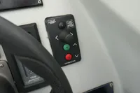 Control panel of a 2007 Custom VSV boat with thruster buttons and steering wheel.