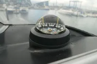 Boat compass on a Custom VSV, 2007 model, with marina background.