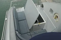 Custom VSV 2007 boat with open storage compartment and cushioned seating on deck.