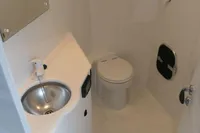 Compact boat bathroom with sink, toilet, and wooden floor, Custom VSV 2007 model.