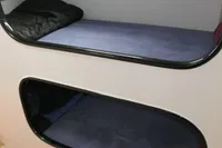 Custom 2007 VSV interior with two bunk beds and a small window.