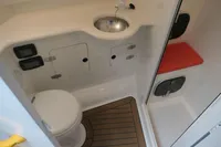 Compact boat bathroom with toilet, sink, and shower in a 2007 Custom VSV model.