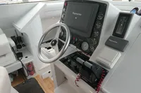 Control panel of a 2007 Custom VSV boat with steering wheel and navigation equipment.