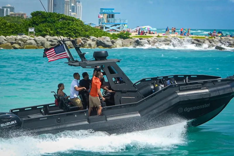  Yacht Photos Pics DGS 777 Military Version boat cruising near beach, 2022 model, with passengers and American flag.