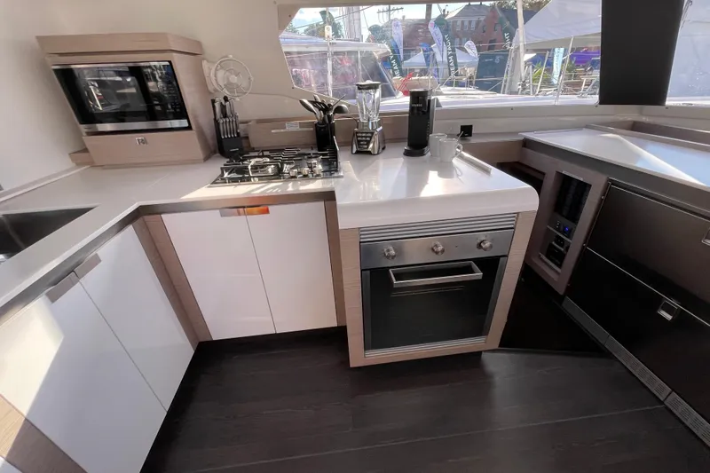 Zensation Yacht Photos Pics Modern kitchen interior of 2023 Fountaine Pajot Tanna 47 yacht with sleek appliances.