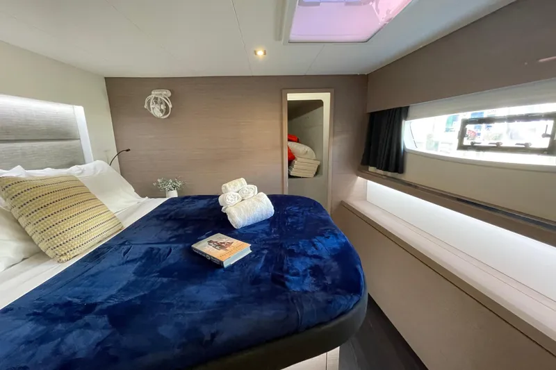 Zensation Yacht Photos Pics Luxurious cabin interior of 2023 Fountaine Pajot Tanna 47 yacht with plush bedding.
