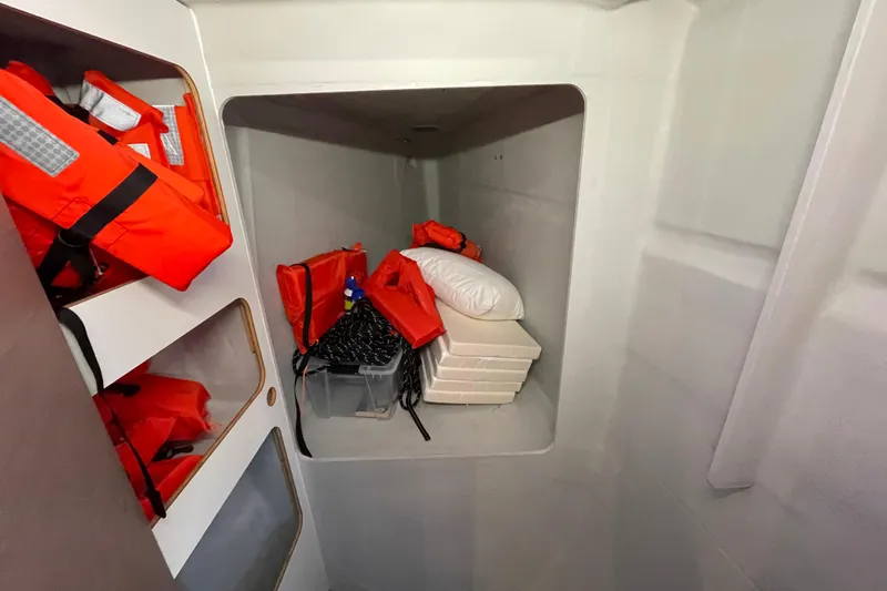 Zensation Yacht Photos Pics Storage area in 2023 Fountaine Pajot Tanna 47 with life jackets and supplies.