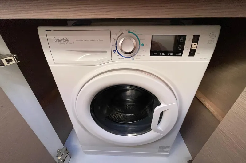 Zensation Yacht Photos Pics Splendide washer-dryer inside 2023 Fountaine Pajot Tanna 47 yacht, compact and efficient design.