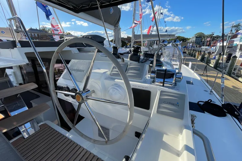 Zensation Yacht Photos Pics 2023 Fountaine Pajot Tanna 47 yacht helm with Garmin navigation system, docked under clear skies.