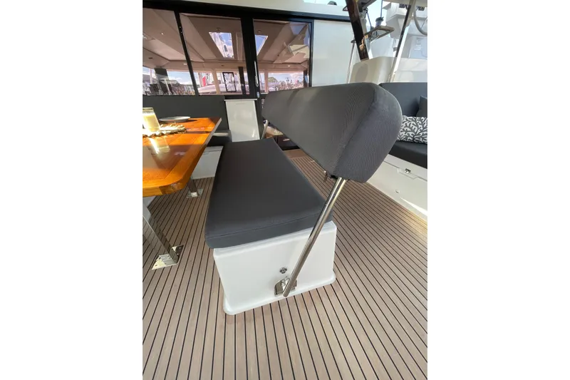 Zensation Yacht Photos Pics Interior seating area of 2023 Fountaine Pajot Tanna 47 yacht with wooden table.