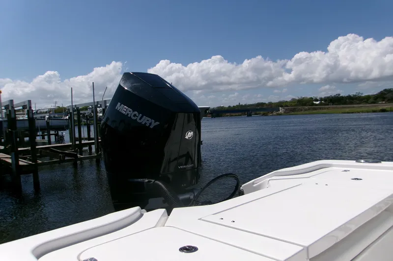  Yacht Photos Pics 2024 Sportsman Masters 267OE Bay Boat with Mercury engine on calm water.