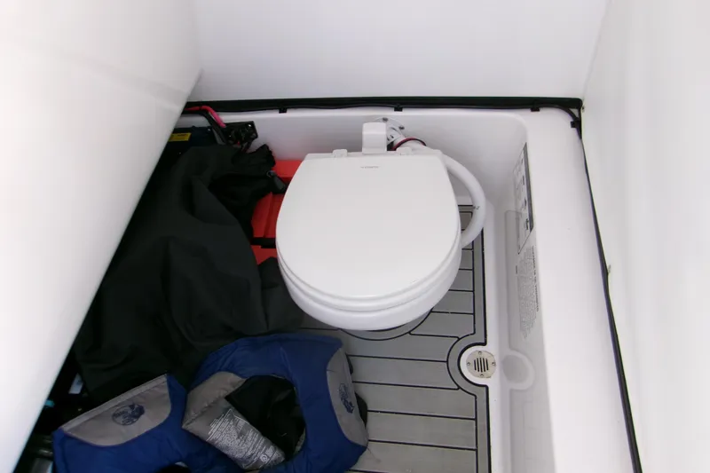  Yacht Photos Pics 2024 Sportsman Masters 267OE Bay Boat interior with toilet and storage area.