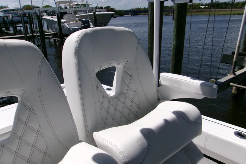  Yacht Photos Pics Luxurious seating on 2024 Sportsman Masters 267OE Bay Boat, featuring elegant white upholstery.