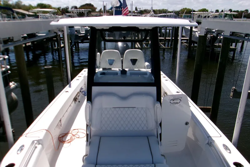  Yacht Photos Pics 2024 Sportsman Masters 267OE Bay Boat docked, showcasing sleek design and spacious seating.