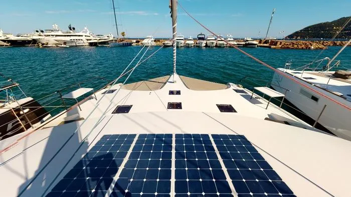 Ti Marin Yacht Photos Pics 2020 O Yachts Class 6 catamaran with solar panels, docked in a marina.