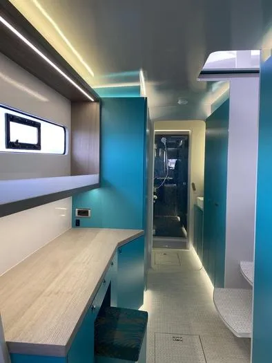 Ti Marin Yacht Photos Pics Interior of 2020 O Yachts Class 6, featuring modern design and vibrant blue cabinetry.