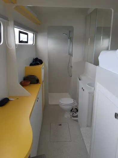 Ti Marin Yacht Photos Pics Interior of 2020 O Yachts Class 6, featuring a modern bathroom with yellow accents.