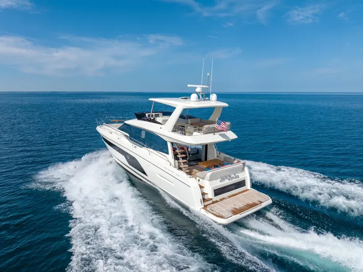  Yacht Photos Pics 2020 Prestige 590 Flybridge Cruiser sailing on open sea under clear blue sky.