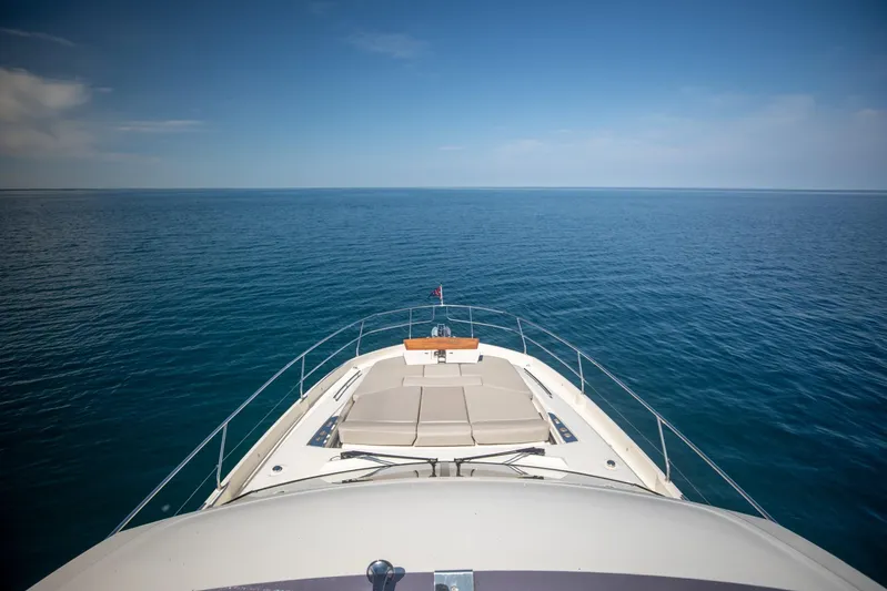  Yacht Photos Pics Prestige 590 Flybridge Cruiser 2020 on open sea, showcasing luxury and expansive ocean view.