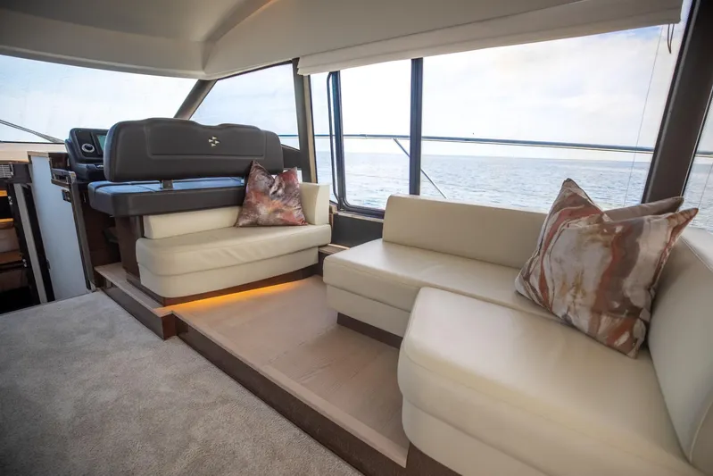  Yacht Photos Pics Luxurious interior of 2020 Prestige 590 Flybridge Cruiser with elegant seating and ocean view.