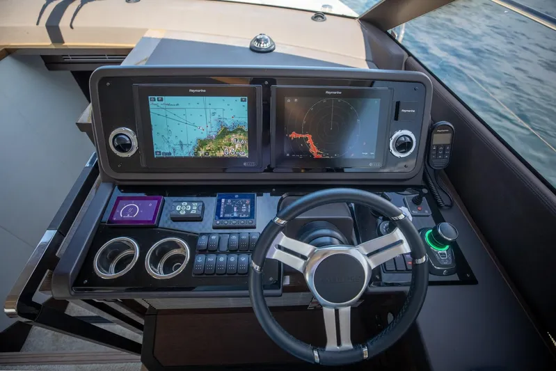  Yacht Photos Pics Helm of 2020 Prestige 590 Flybridge Cruiser with navigation screens and controls.