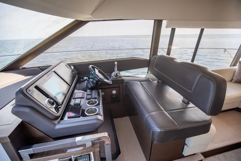  Yacht Photos Pics 2020 Prestige 590 Flybridge Cruiser helm with leather seating and modern navigation controls.