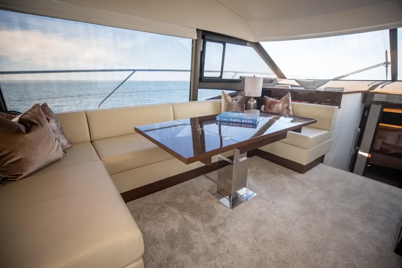  Yacht Photos Pics Luxurious interior of 2020 Prestige 590 Flybridge Cruiser with elegant seating and ocean view.