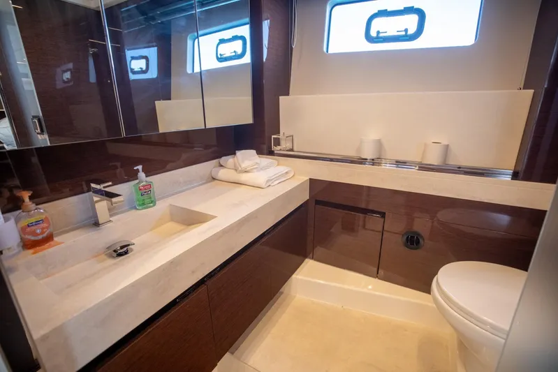  Yacht Photos Pics Luxurious bathroom in 2020 Prestige 590 Flybridge Cruiser yacht, featuring modern fixtures and elegant design.