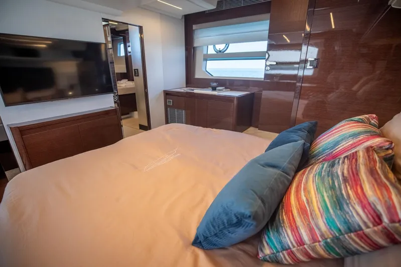  Yacht Photos Pics Luxurious bedroom interior of 2020 Prestige 590 Flybridge Cruiser with modern decor and vibrant pillows.