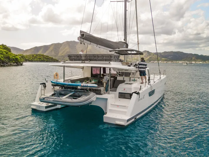  Yacht Photos Pics 2023 Fountaine Pajot Tanna 47 catamaran sailing in scenic coastal waters.