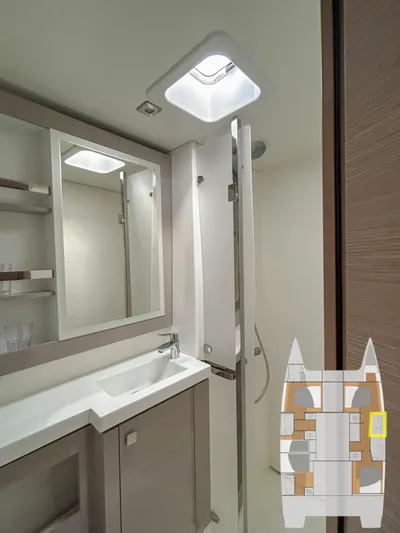  Yacht Photos Pics Modern bathroom interior of 2023 Fountaine Pajot Tanna 47 catamaran with sleek design and fixtures.