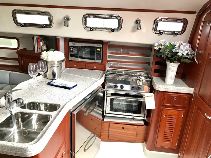 Salacia Yacht Photos Pics Luxurious 2016 Blue Jacket 40 yacht interior with modern kitchen and elegant wood finish.