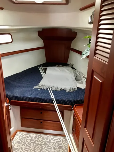 Salacia Yacht Photos Pics Cozy cabin interior of 2016 Blue Jacket 40 sailboat with wooden furnishings and patterned carpet.