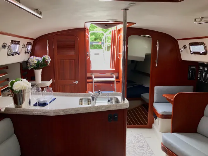 Salacia Yacht Photos Pics Luxurious interior of 2016 Blue Jacket 40 sailboat with elegant wood finish and modern amenities.