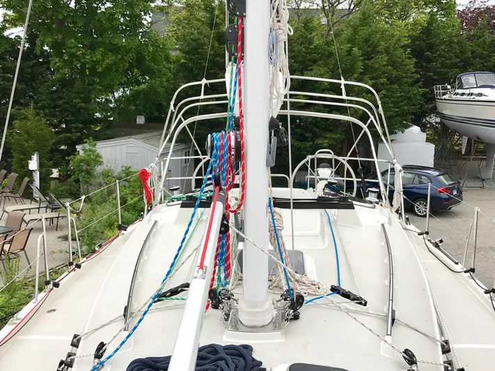 Salacia Yacht Photos Pics Sailboat deck with colorful ropes, Blue Jacket 40, 2016 model, surrounded by greenery and parked cars.